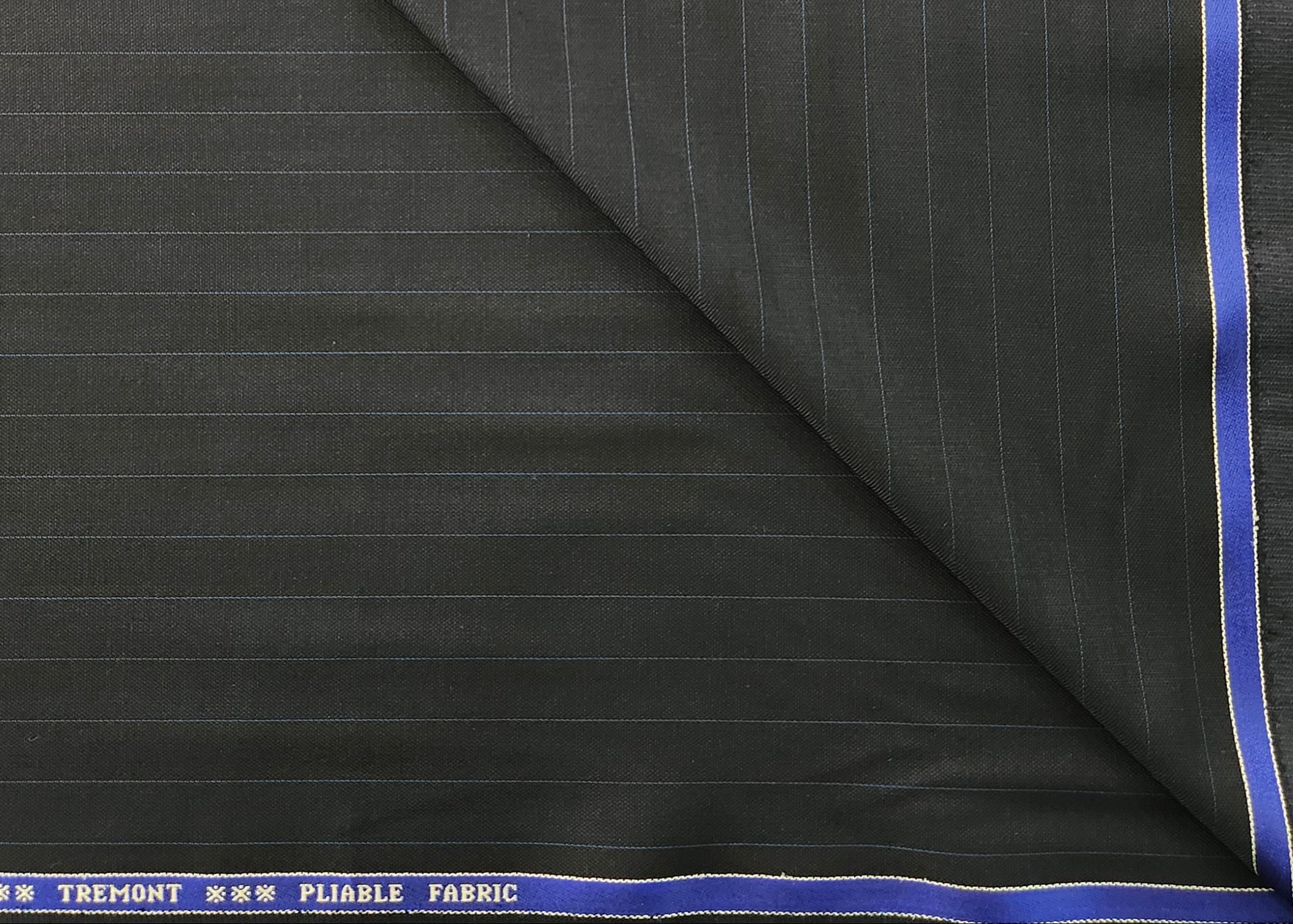 Black pinstripe fabric with blue border and 'Tremont' branding